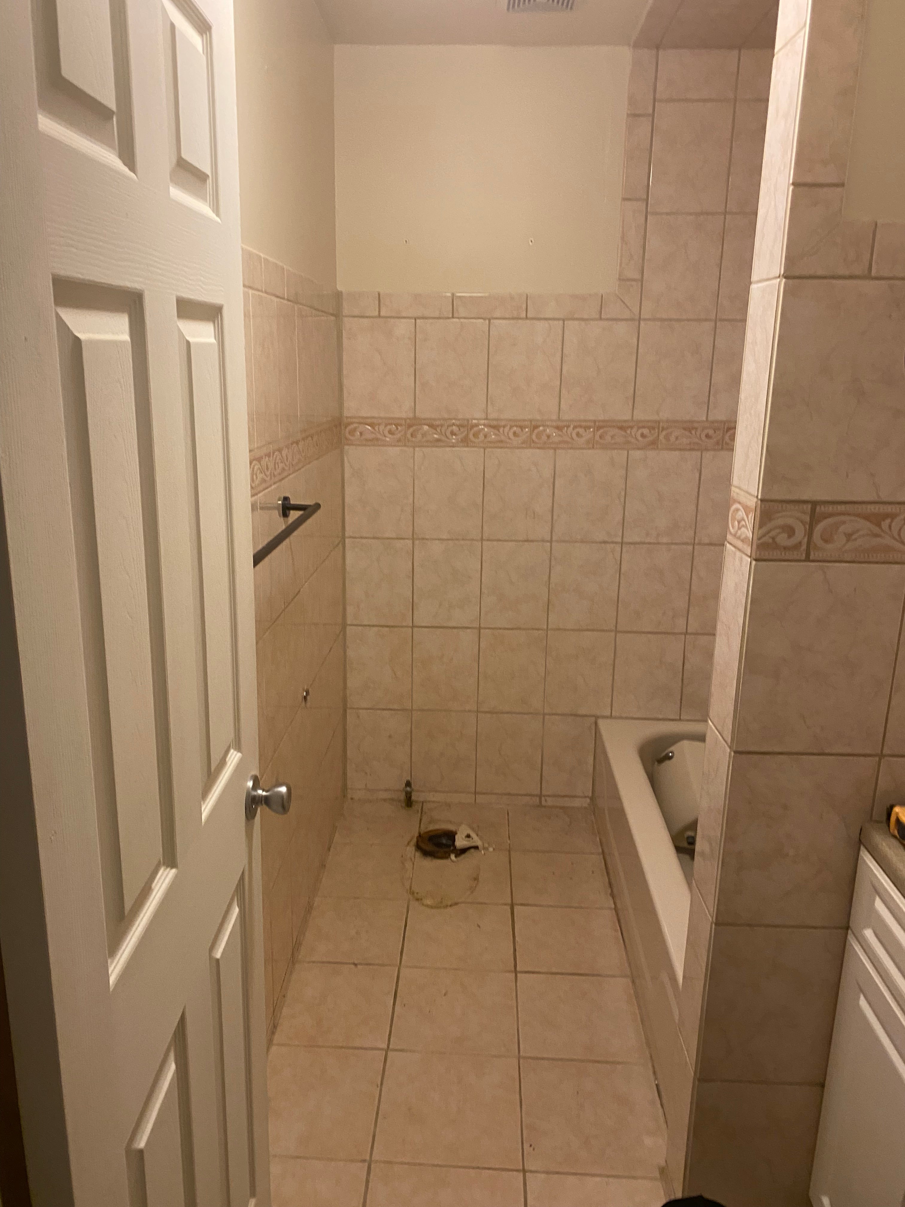 before picture Bathroom with tiled walls and a shower area.