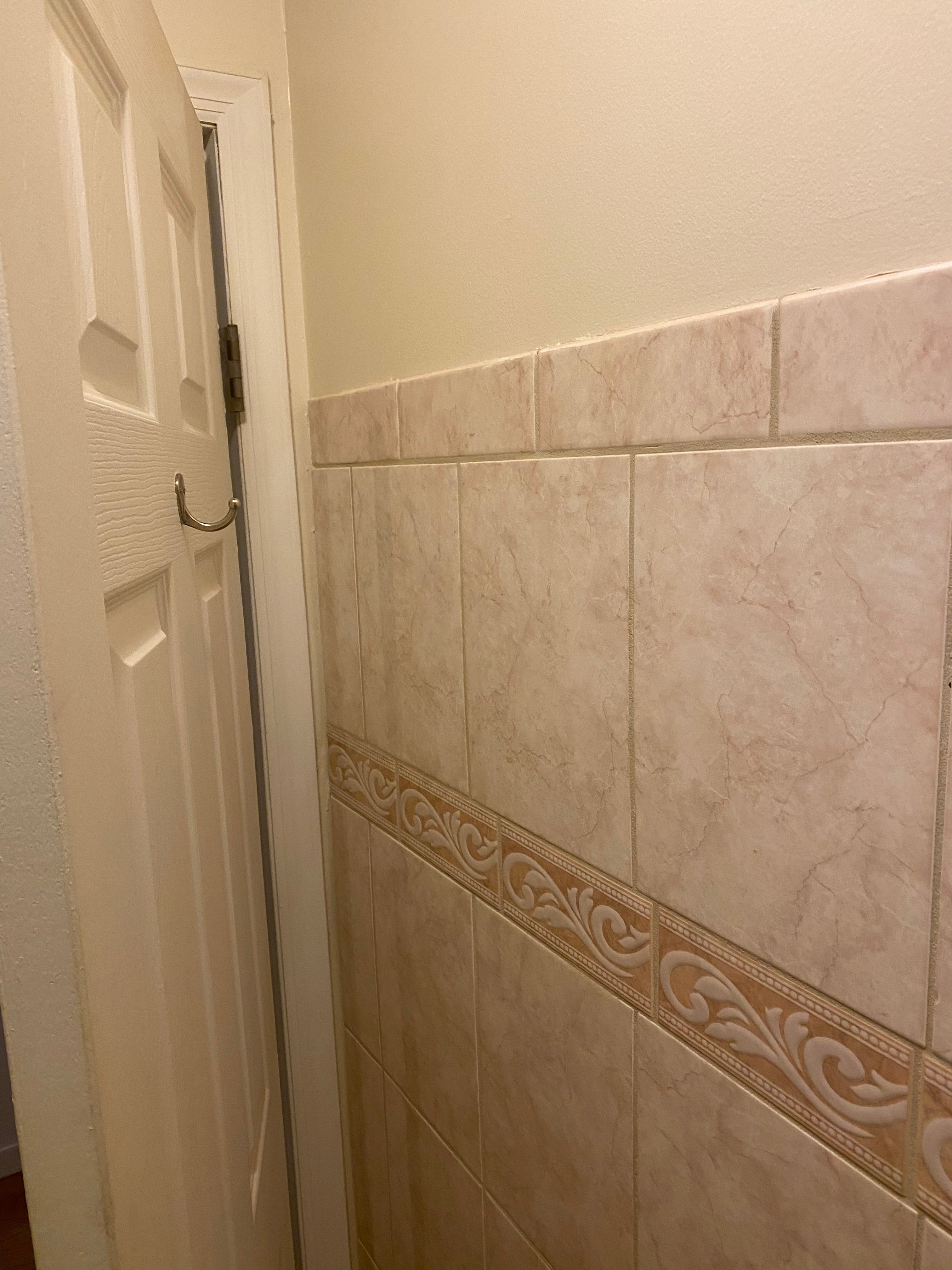 Ceiling with decorative border and white door