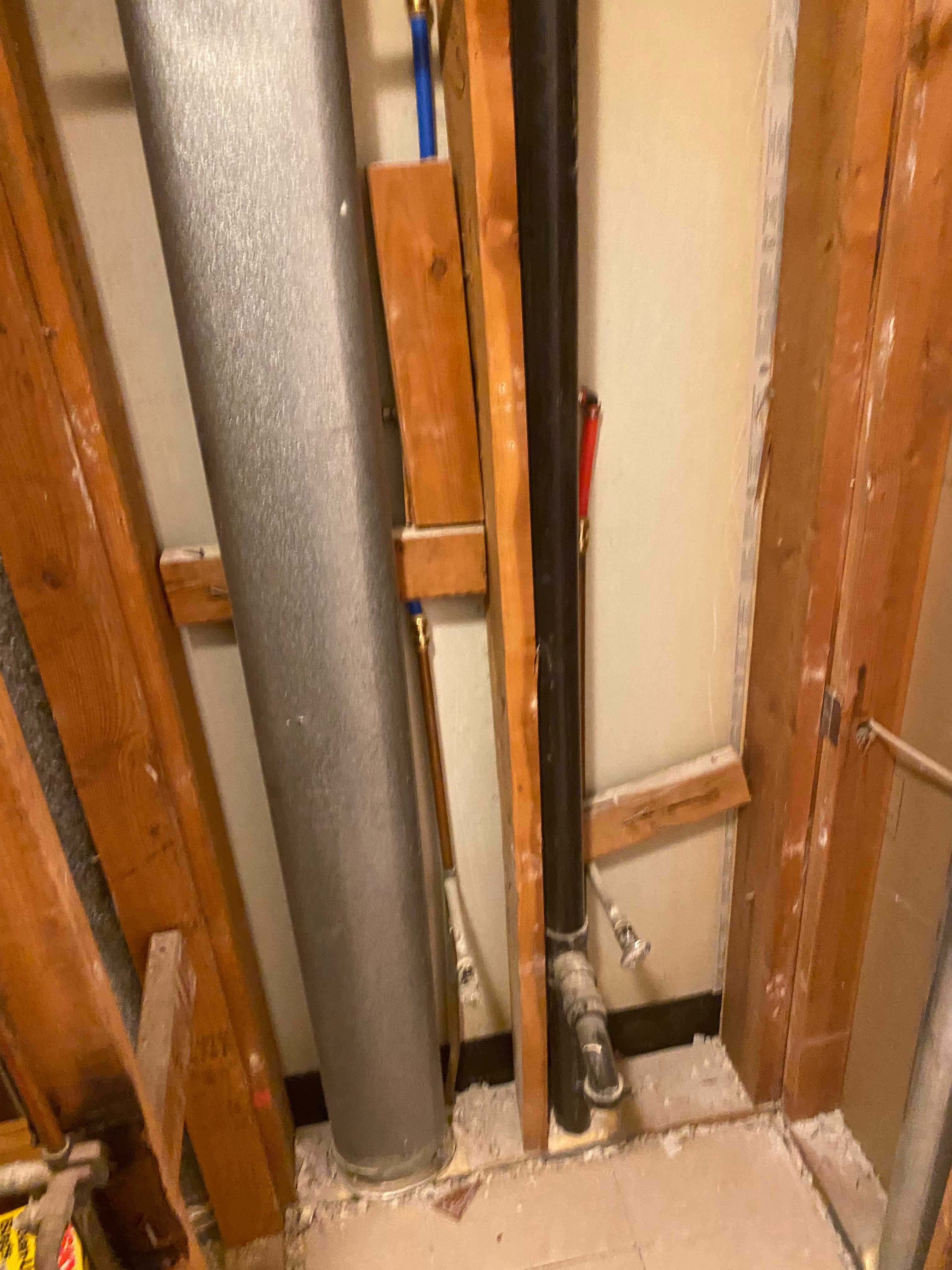 Wooden beams and metal pipes on a wooden platform in an industrial setting