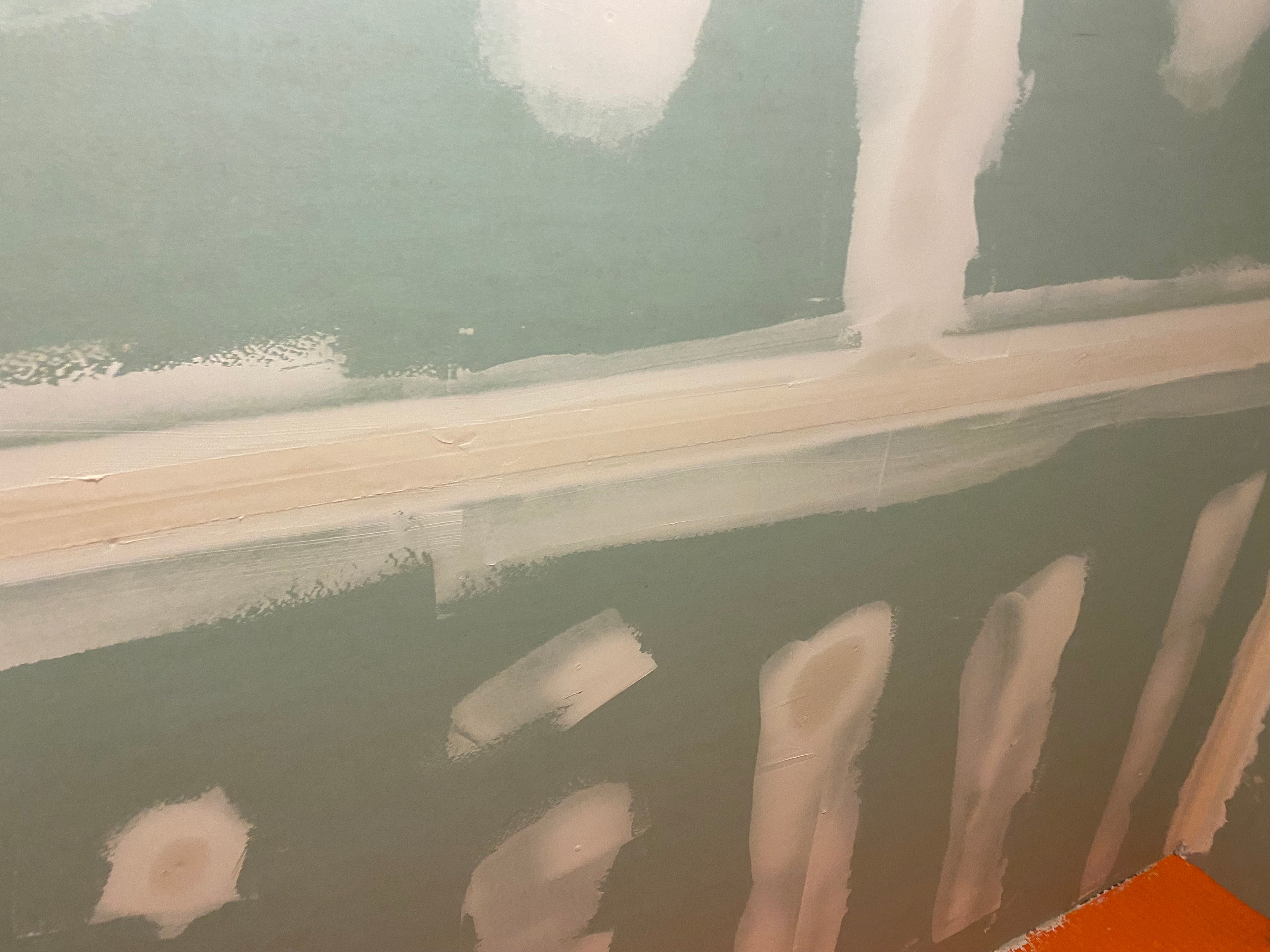 Close-up of a green   moisturize sheetrock with joint compound on the seams