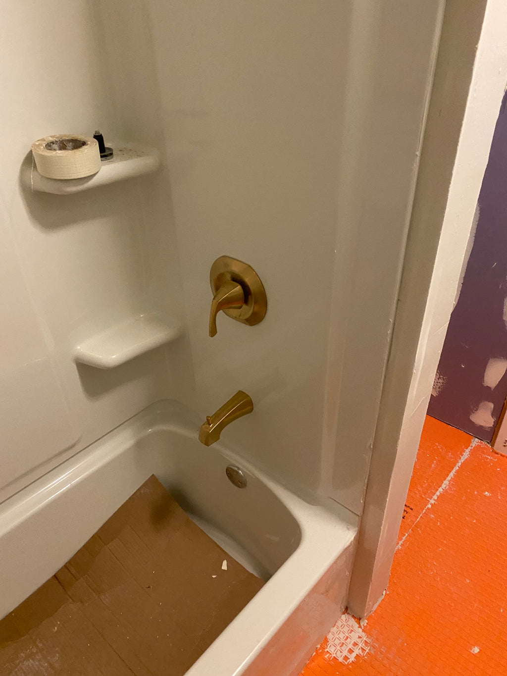 white enclosure and water proof membrane on the floor before tiling