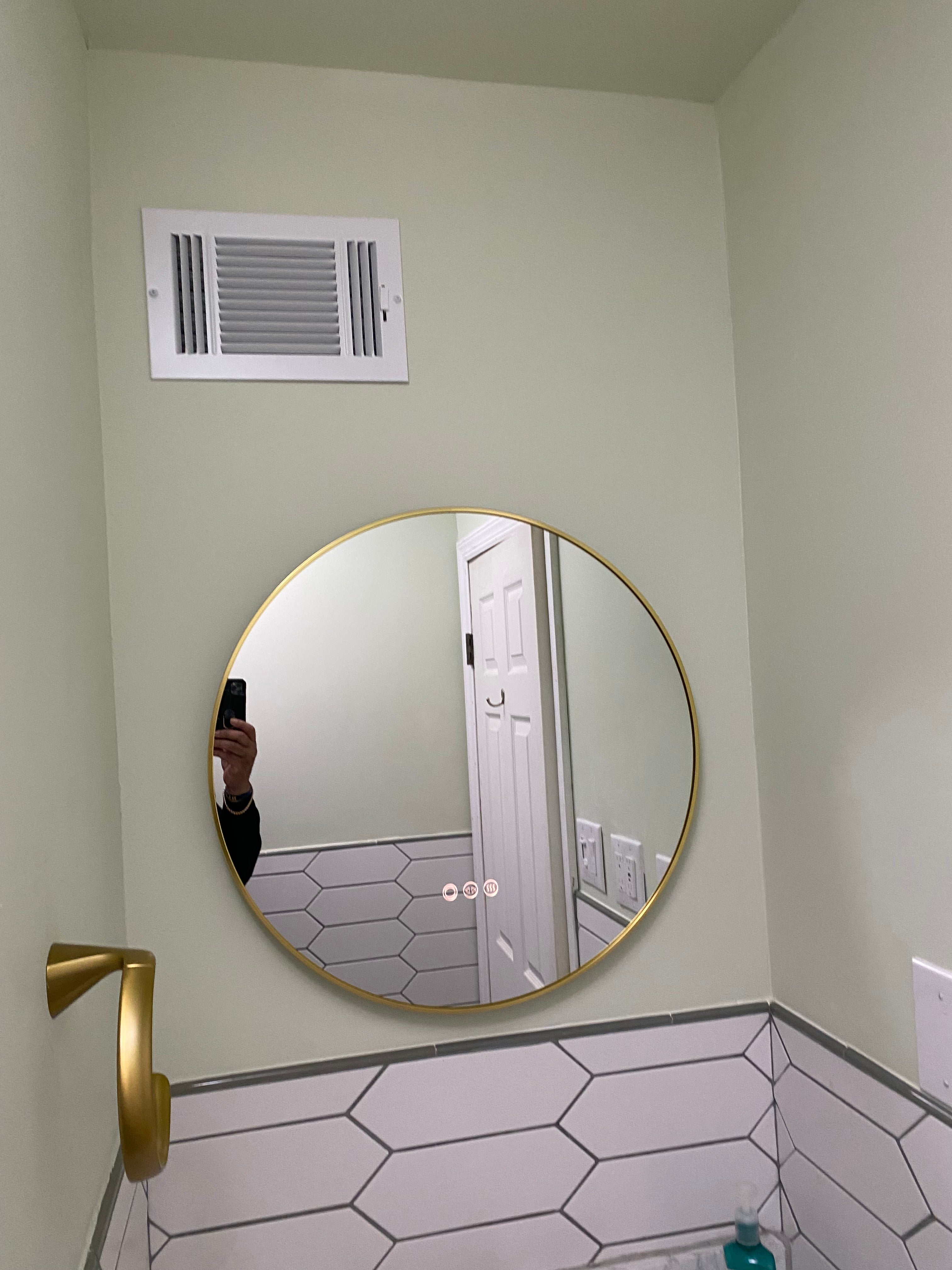 Installed round mirror and hand towel installed