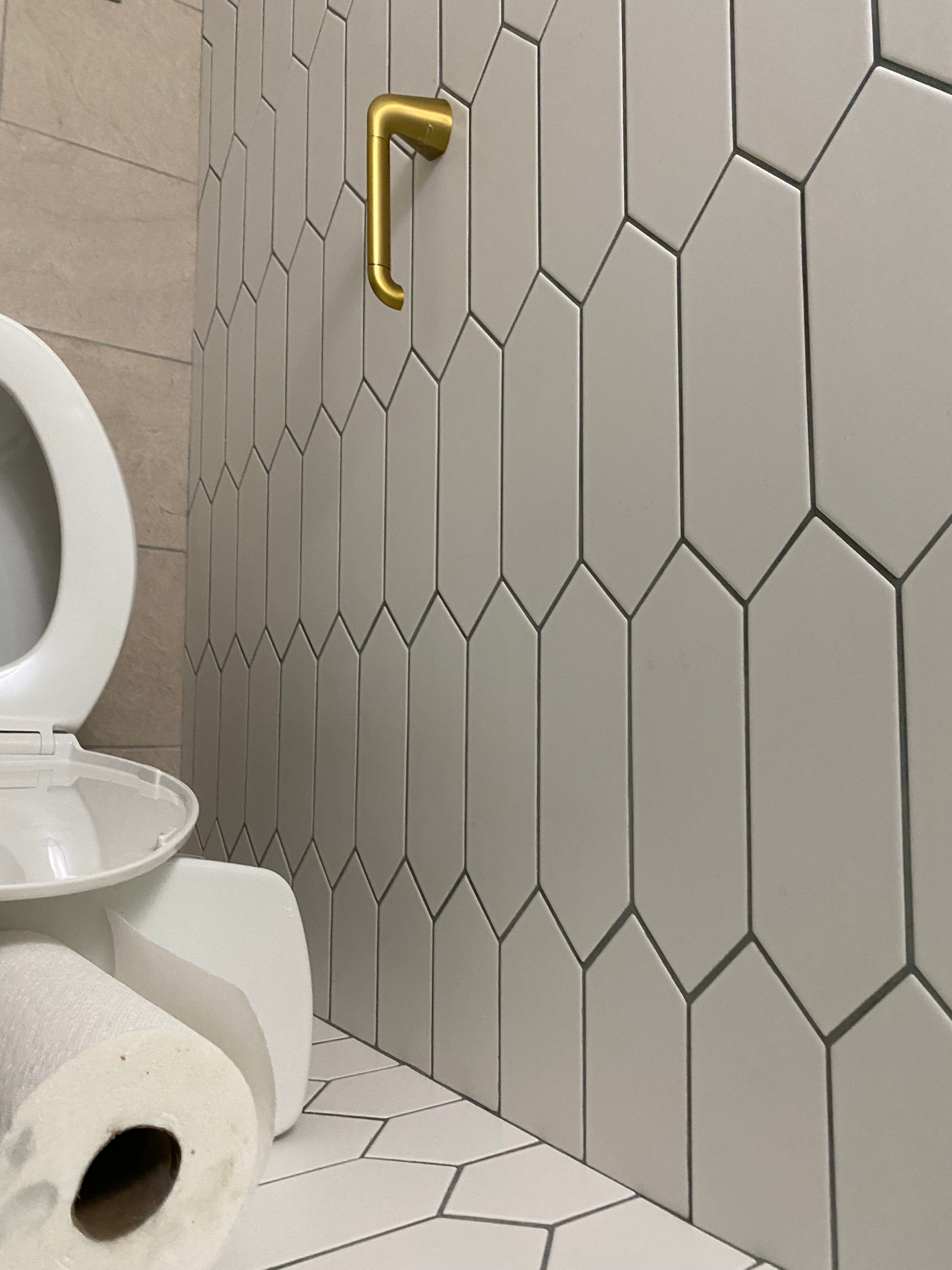 finished white tiles on the wall and new tissue holder